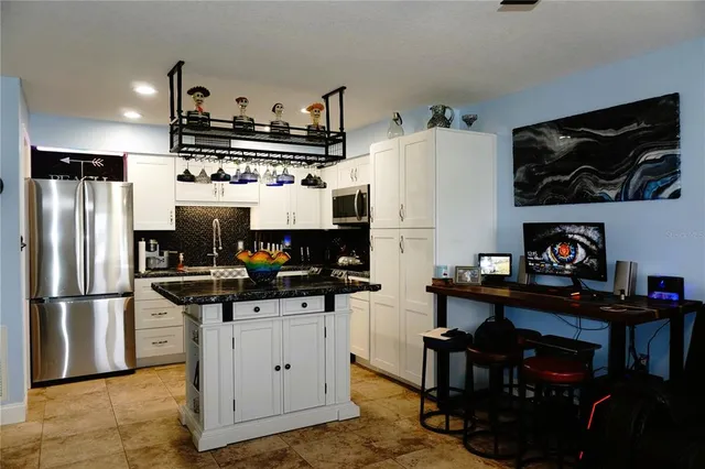 a kitchen with stainless steel appliances a refrigerator stove and microwave