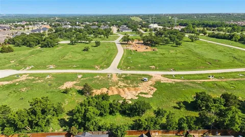a view of a grassy field with trees