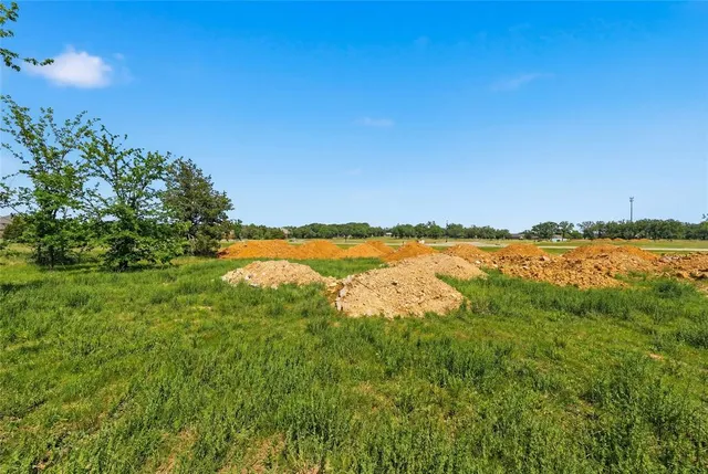 an aerial view of residential houses with outdoor space and ocean view
