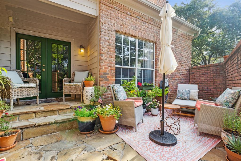 a building outdoor space with patio furniture and potted plants