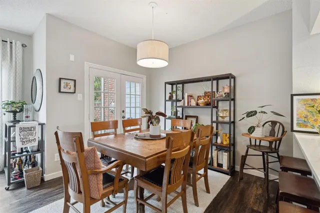 a view of a dining room with furniture wooden floor and chandelier