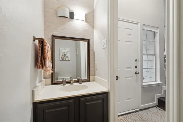 a bathroom with a sink vanity and a mirror