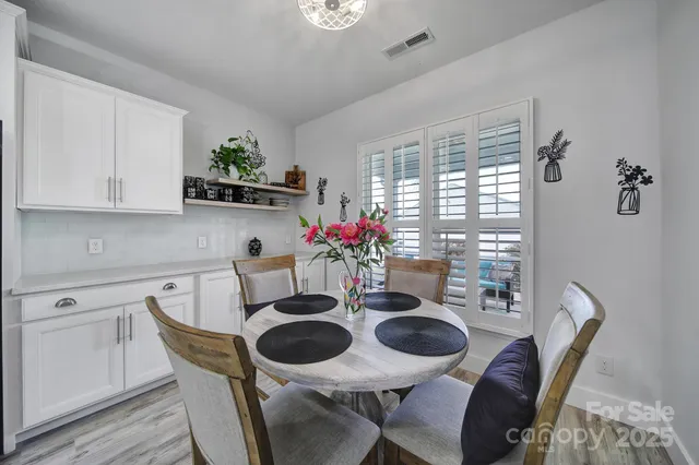 a dining room with furniture and wooden floor