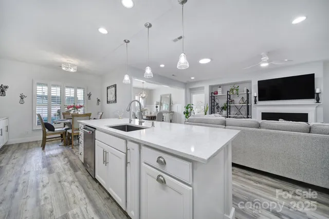 a large white kitchen with a large window