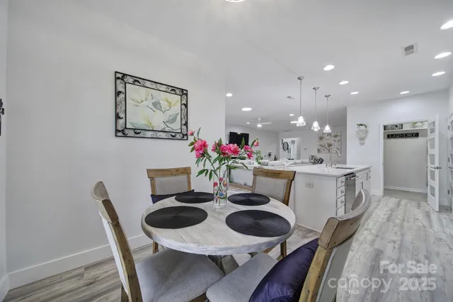 a dining room with furniture and wooden floor