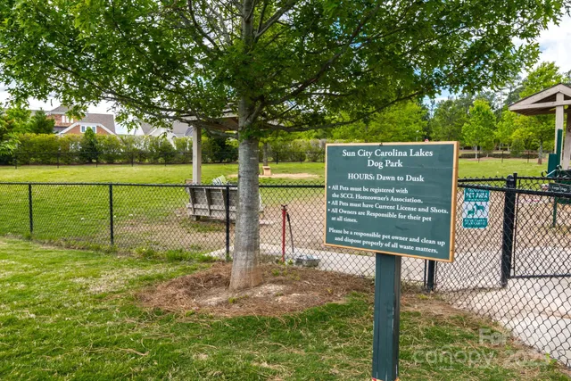 a view of a park with iron fence