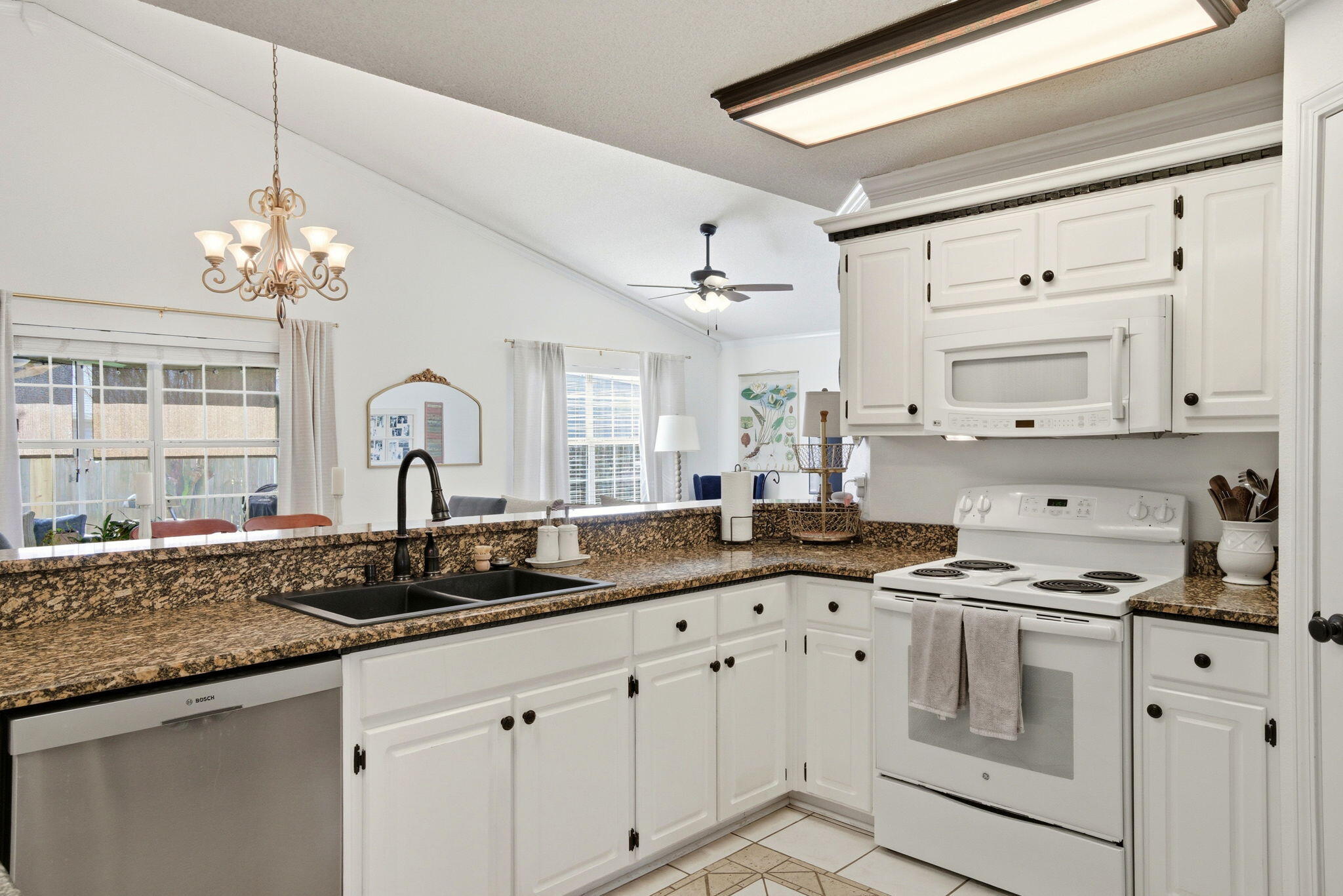 570 Rough Leaf Lane Mary Esther, FL 32569 - Photo 14 of 58 a kitchen with granite countertop a white cabinets and window