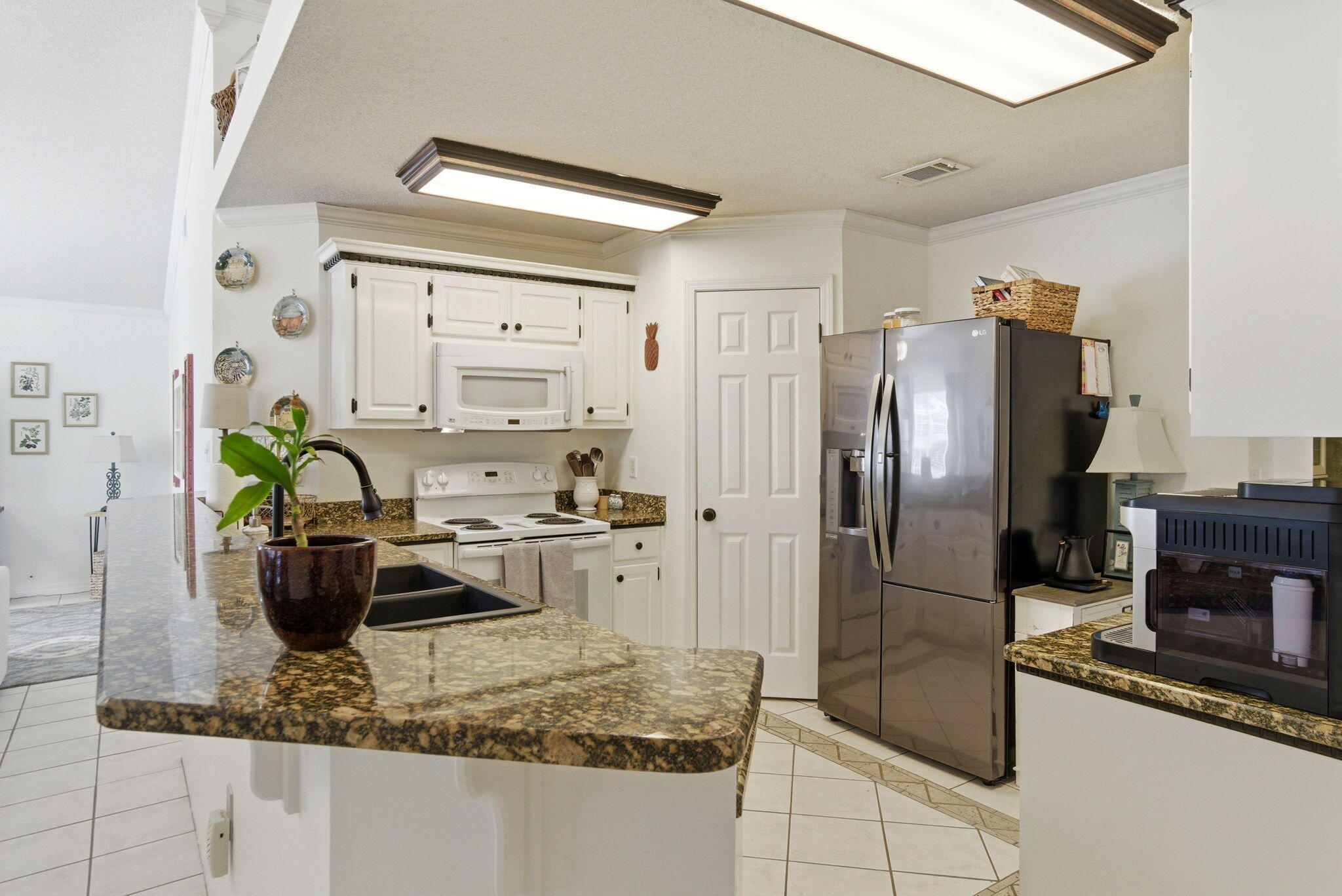 570 Rough Leaf Lane Mary Esther, FL 32569 - Photo 15 of 58 a kitchen with stainless steel appliances granite countertop a refrigerator and a sink