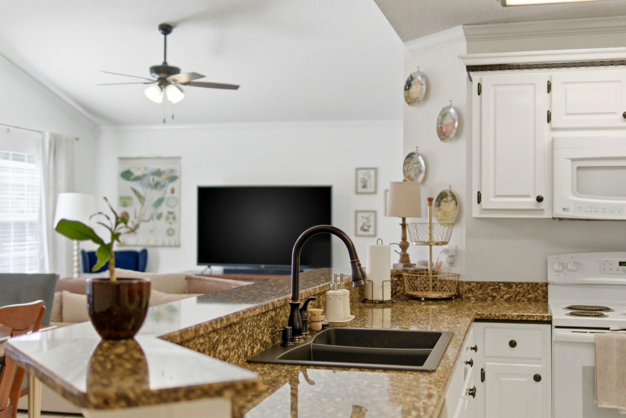 570 Rough Leaf Lane Mary Esther, FL 32569 - Photo 16 of 58 a kitchen with a stove and a white cabinets