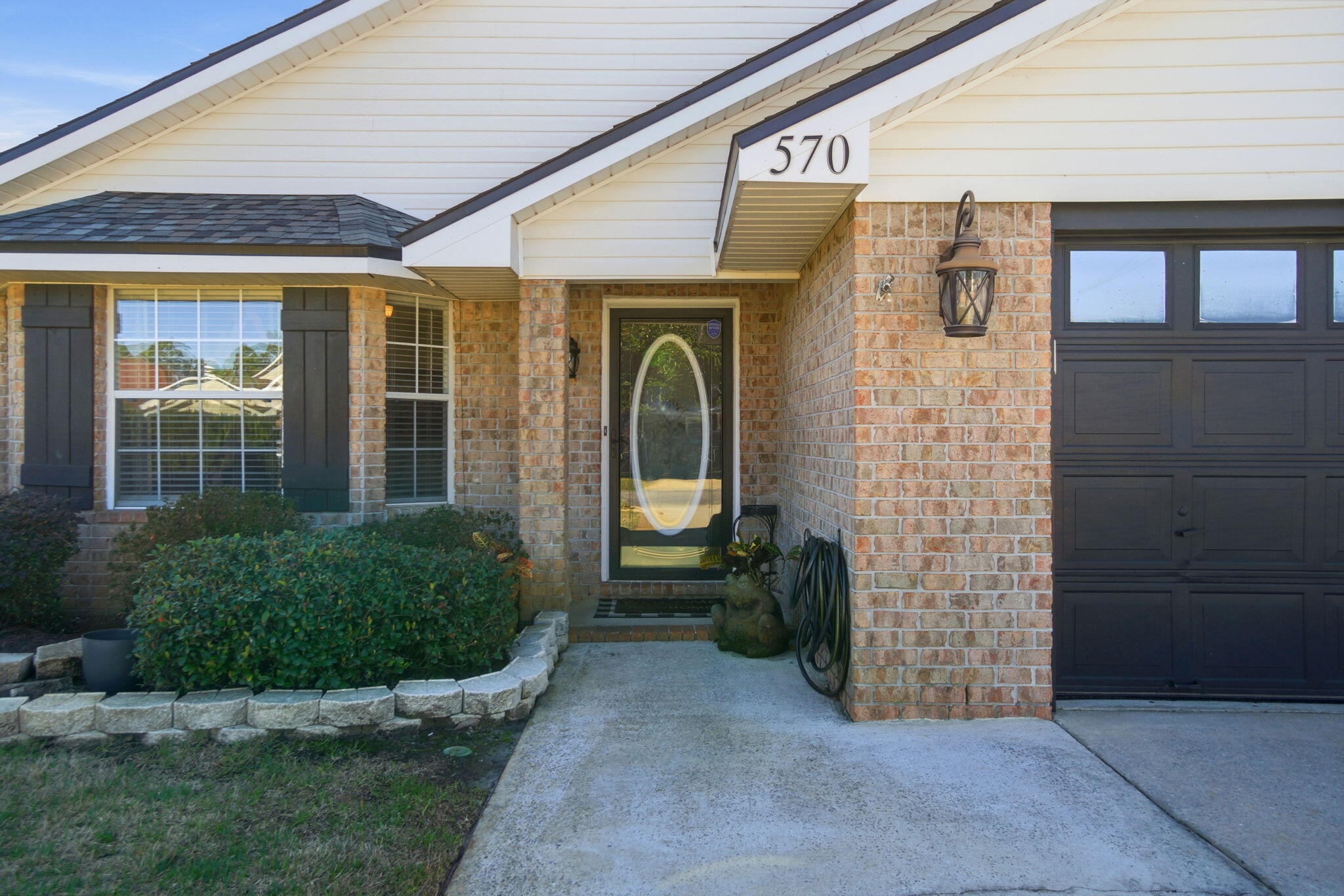 570 Rough Leaf Lane Mary Esther, FL 32569 - Photo 2 of 58 a front view of a house with a garden