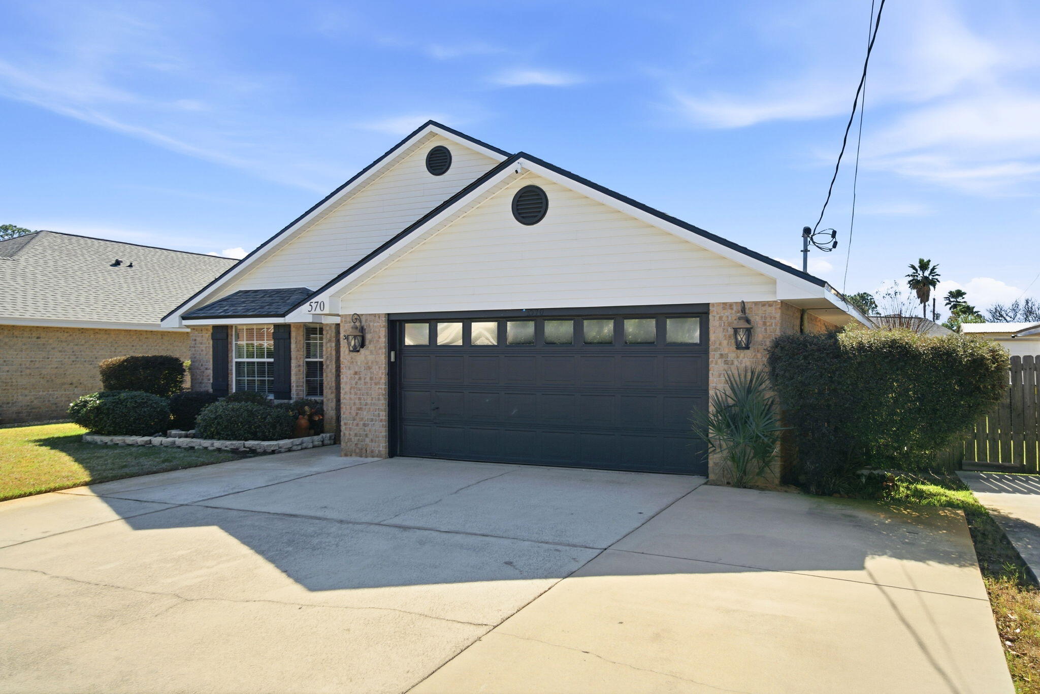 570 Rough Leaf Lane Mary Esther, FL 32569 - Photo 4 of 58 a front view of a house with garden