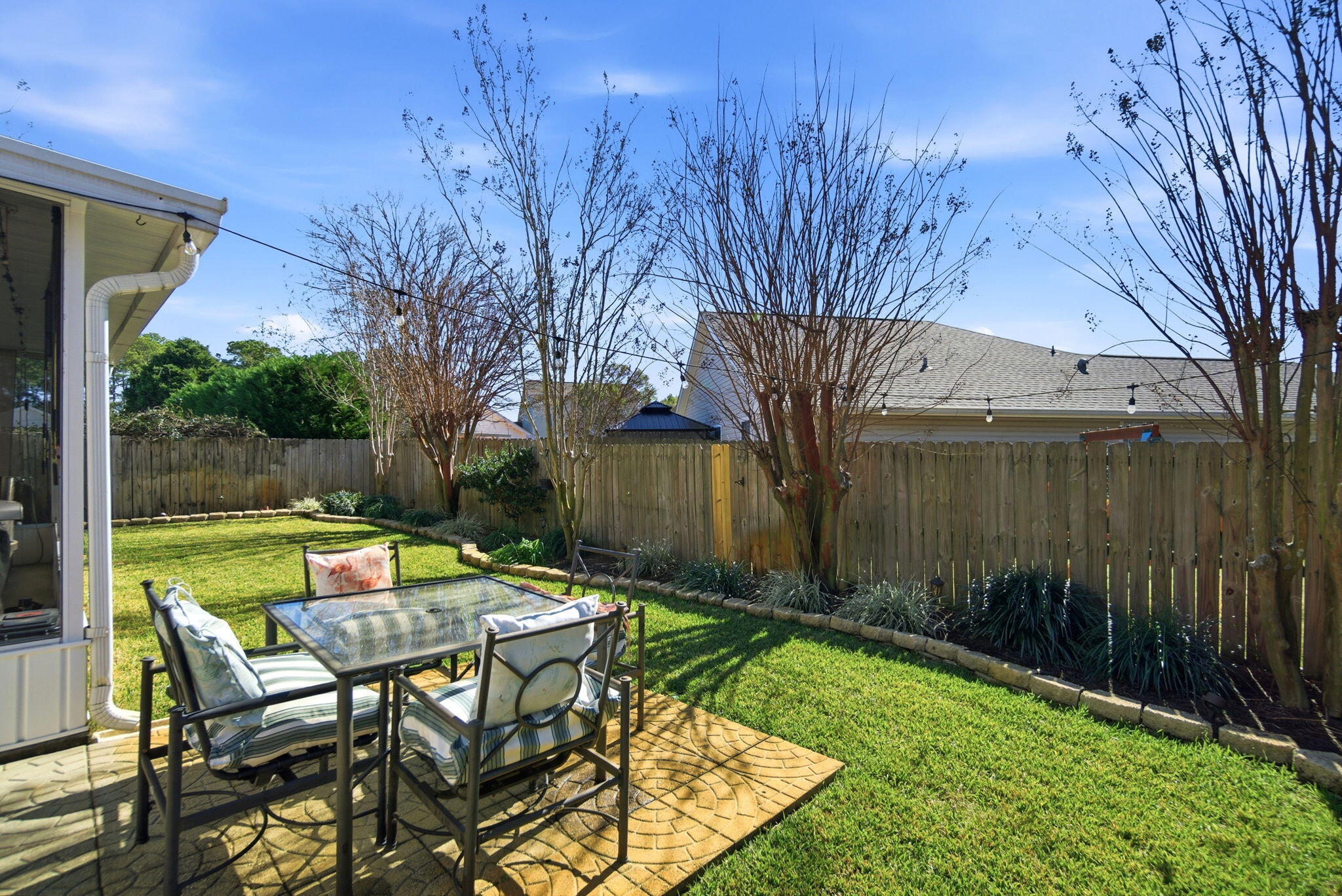 570 Rough Leaf Lane Mary Esther, FL 32569 - Photo 55 of 58 a backyard of a house with table and chairs