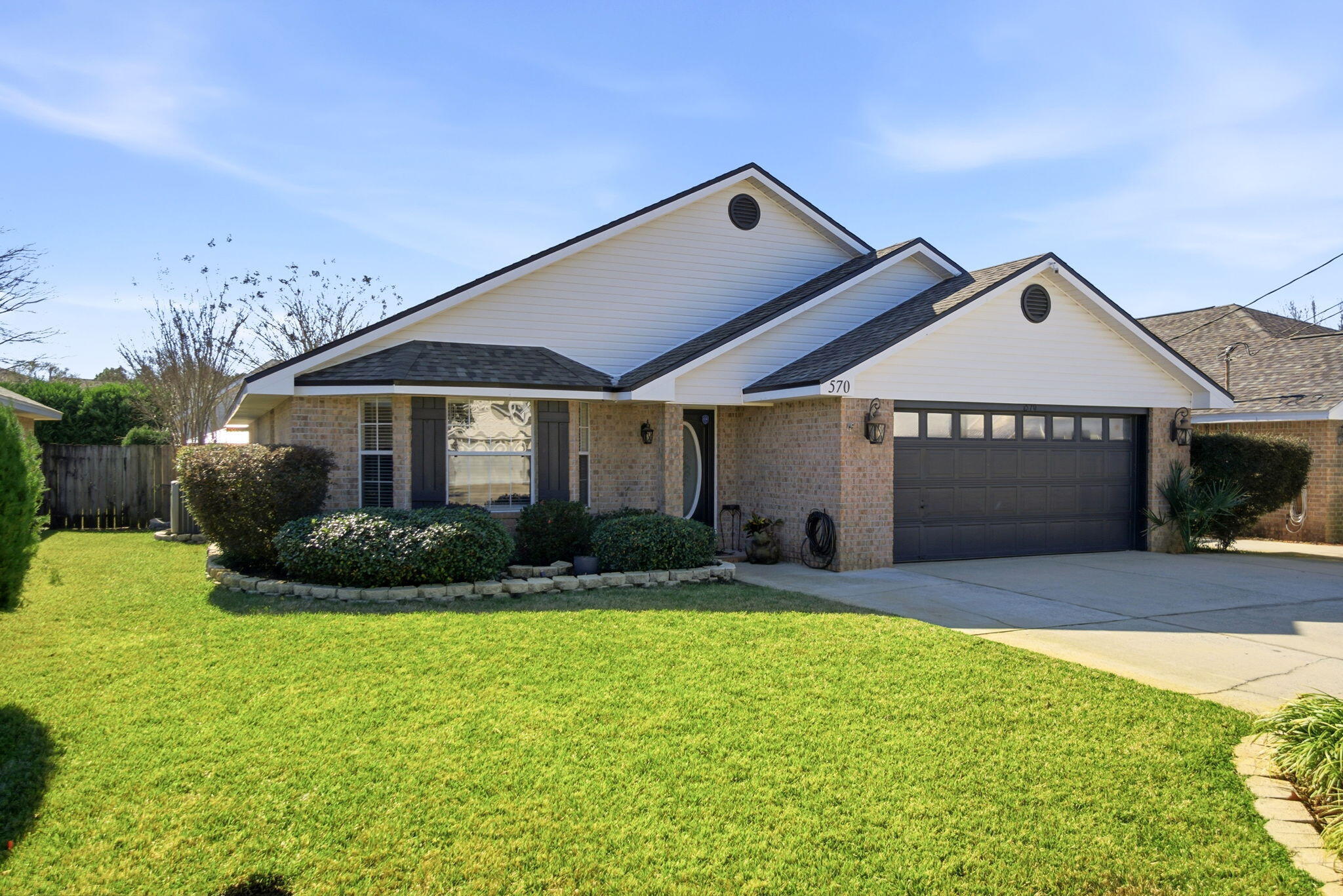 570 Rough Leaf Lane Mary Esther, FL 32569 - Photo 58 of 58 a front view of a house with a yard and garage