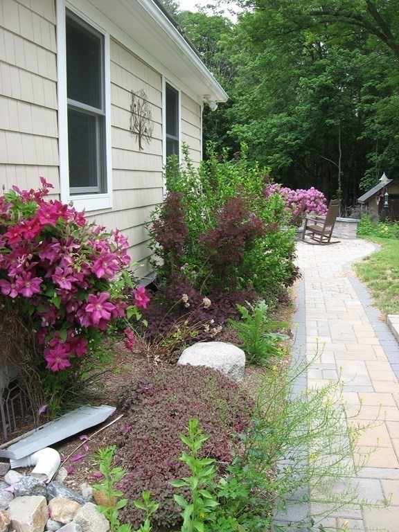2 Fieldcrest Road Sturbridge, MA 01566 - Photo 13 of 39 a flower plants in front of the house