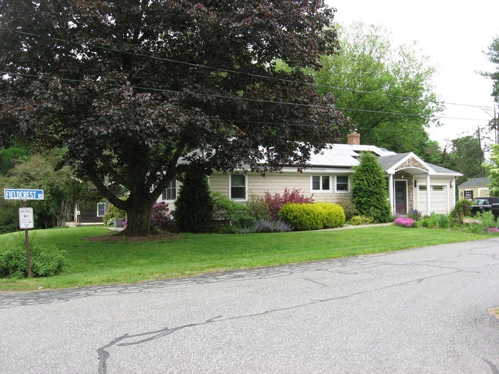 2 Fieldcrest Road Sturbridge, MA 01566 - Photo 14 of 39 a front view of a house with a yard and garage
