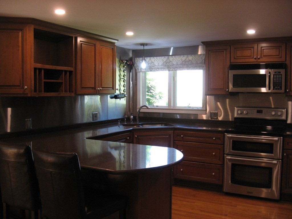 2 Fieldcrest Road Sturbridge, MA 01566 - Photo 33 of 39 a kitchen with kitchen island granite countertop a sink stainless steel appliances and cabinets
