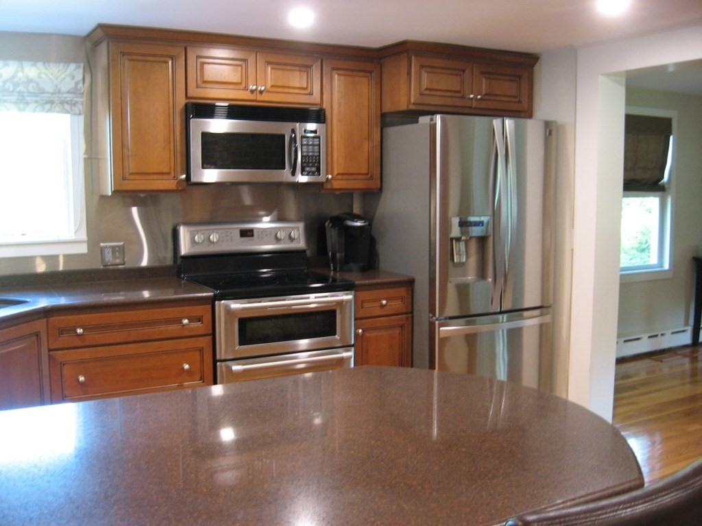 2 Fieldcrest Road Sturbridge, MA 01566 - Photo 34 of 39 a kitchen with granite countertop a refrigerator stove and microwave
