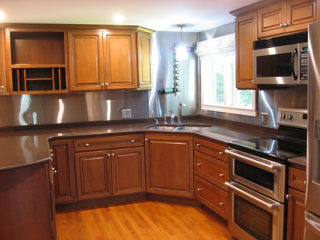 2 Fieldcrest Road Sturbridge, MA 01566 - Photo 36 of 39 a kitchen with stainless steel appliances granite countertop a stove a sink and a microwave