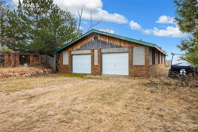 4775 Meridian Road Peyton, CO 80831 - Photo 24 of 25 View of attached garage