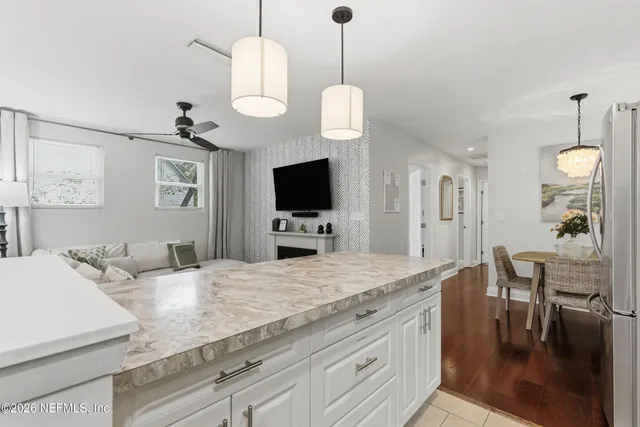 a view of living room with granite countertop furniture and a flat screen tv
