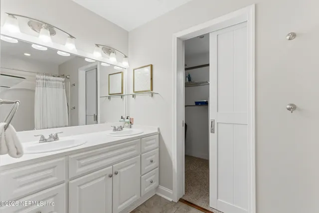 a bathroom with a double vanity sink mirror and