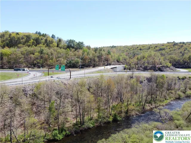 a kitchen with stainless steel appliances granite countertop a kitchen island hardwood floor sink and stove