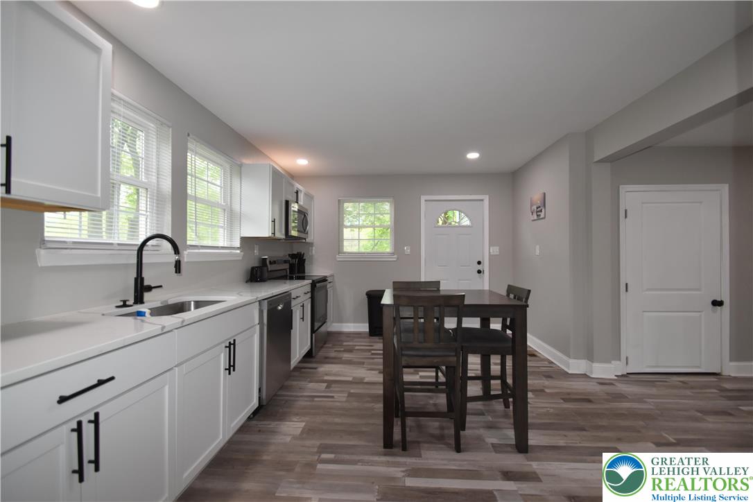 1500 Rock Street, Unit 1 Lehighton, PA 18235 - Photo 28 of 67 a kitchen with stainless steel appliances granite countertop a sink a stove a dining table and chairs