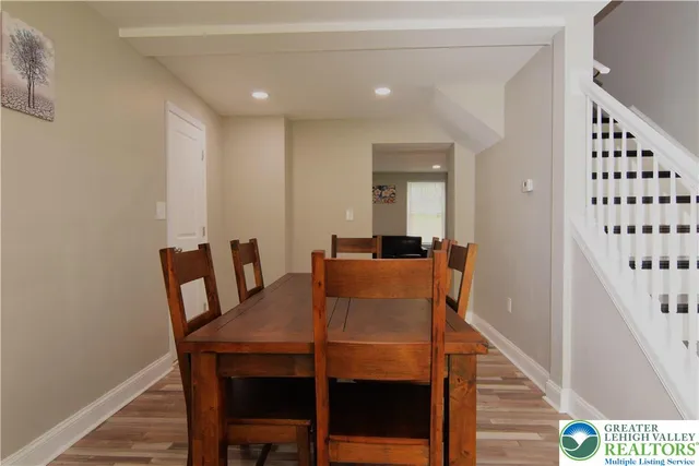 a view of a bedroom with cabinet mirror and window