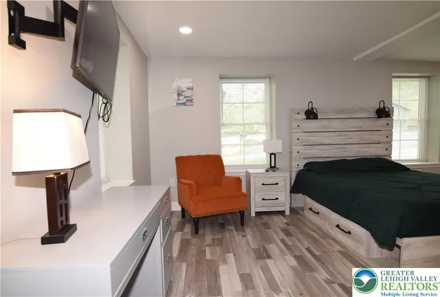 a bedroom with a bed and a view of kitchen