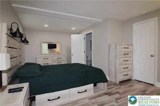 a bedroom with a bed and a flat screen tv