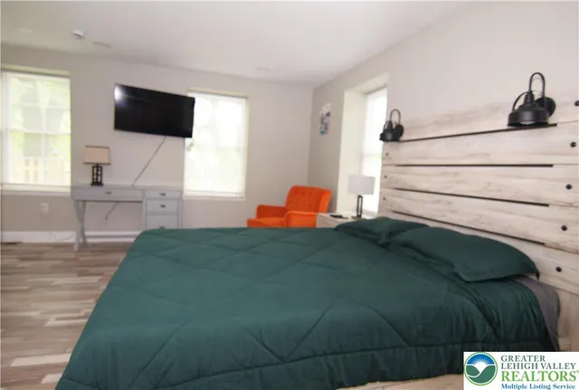 a bedroom with a bed and a flat screen tv