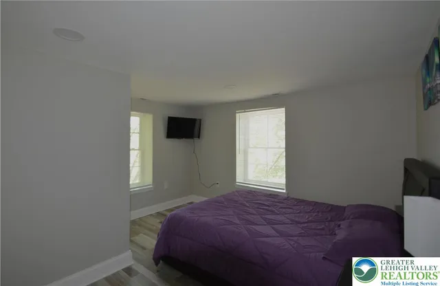 a bedroom with a bed and window