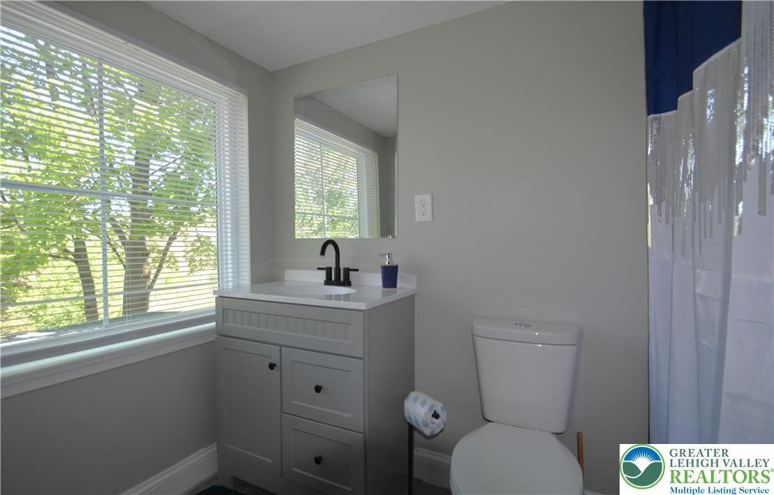1500 Rock Street, Unit 1 Lehighton, PA 18235 - Photo 51 of 67 a bathroom with a toilet sink a window and mirror