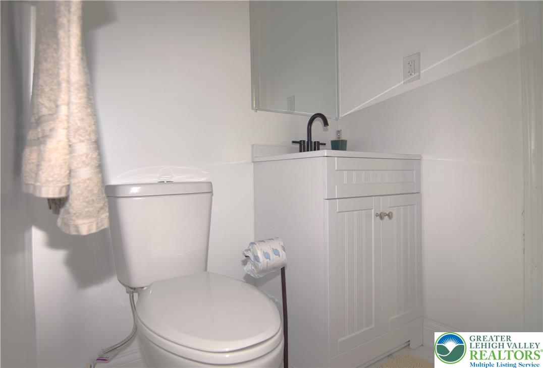 1500 Rock Street, Unit 1 Lehighton, PA 18235 - Photo 56 of 67 a white toilet sitting next to a bathroom sink