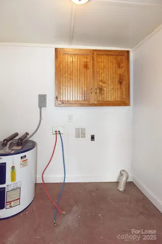 a view of a house with a yard and large tree
