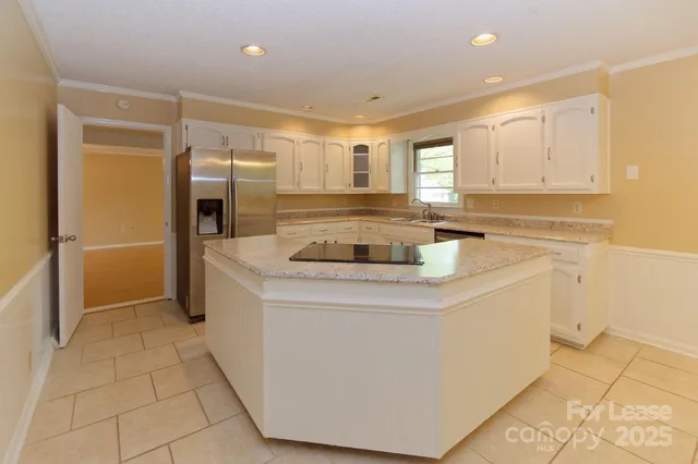 a kitchen with stainless steel appliances a refrigerator sink and cabinets
