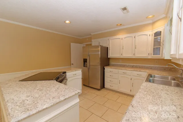a kitchen with a stove refrigerator and cabinets