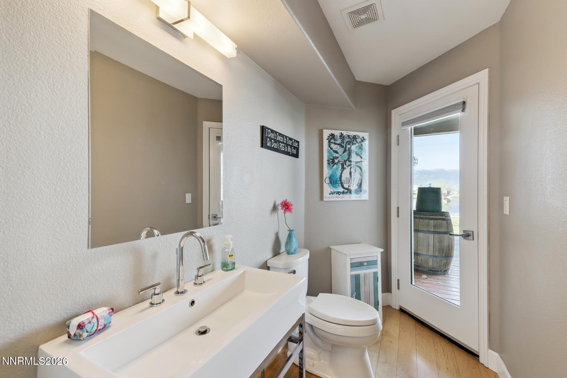 1608 East Valley Road Gardnerville, NV 89410 - Photo 19 of 54 a bathroom with a sink mirror and toilet