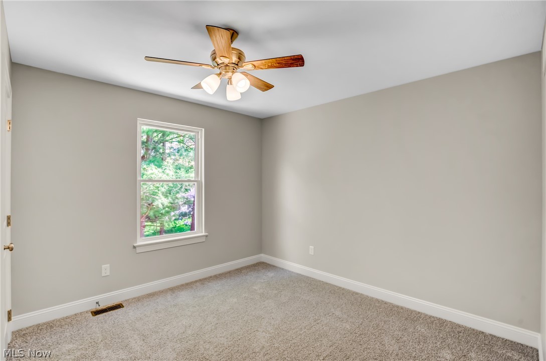 12412 Snow Road Burton, OH 44021 - Photo 29 of 45 Carpeted spare room featuring ceiling fan