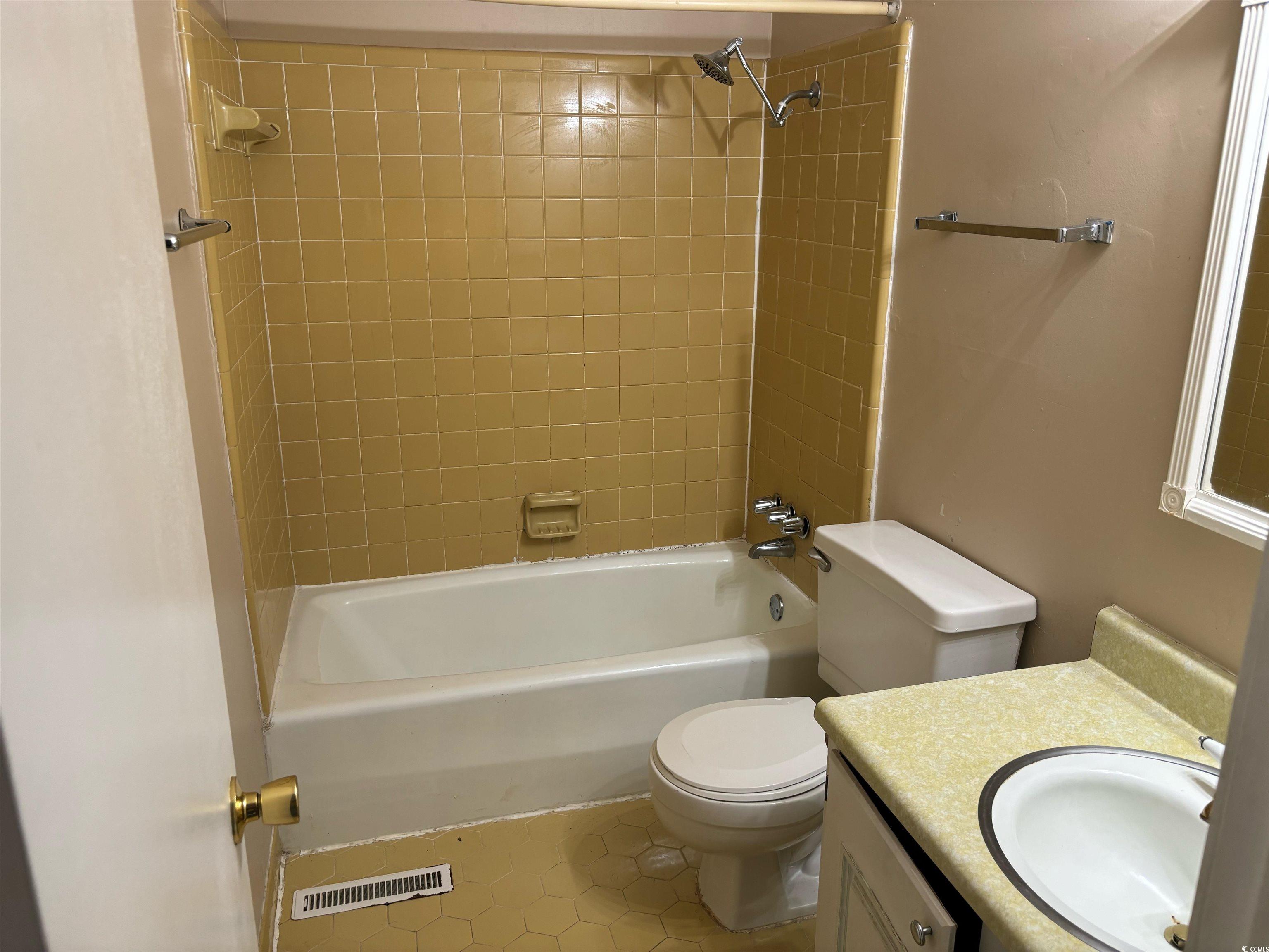 1025 Carolina Road, Unit G3 Conway, SC 29526 - Photo 4 of 11 Full bathroom with toilet, tiled shower / bath, vanity, and tile patterned floors