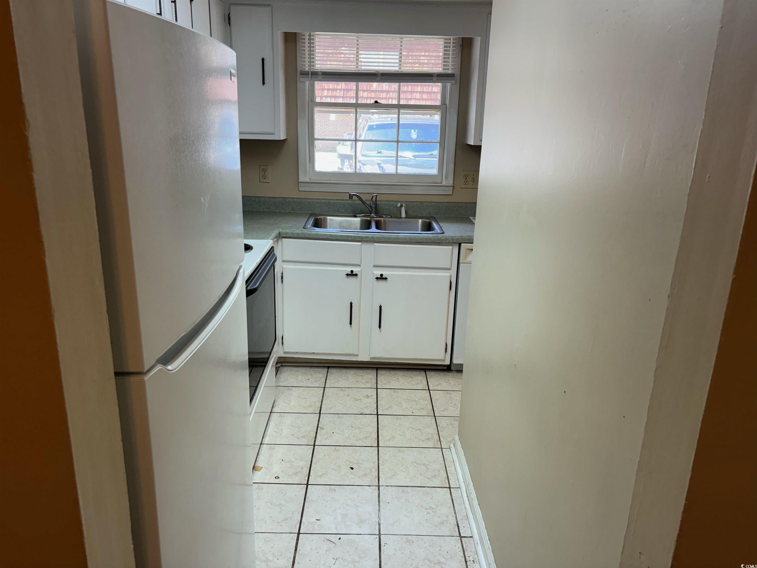 1025 Carolina Road, Unit G3 Conway, SC 29526 - Photo 6 of 11 Kitchen with sink, white cabinetry, white appliances, and light tile patterned floors