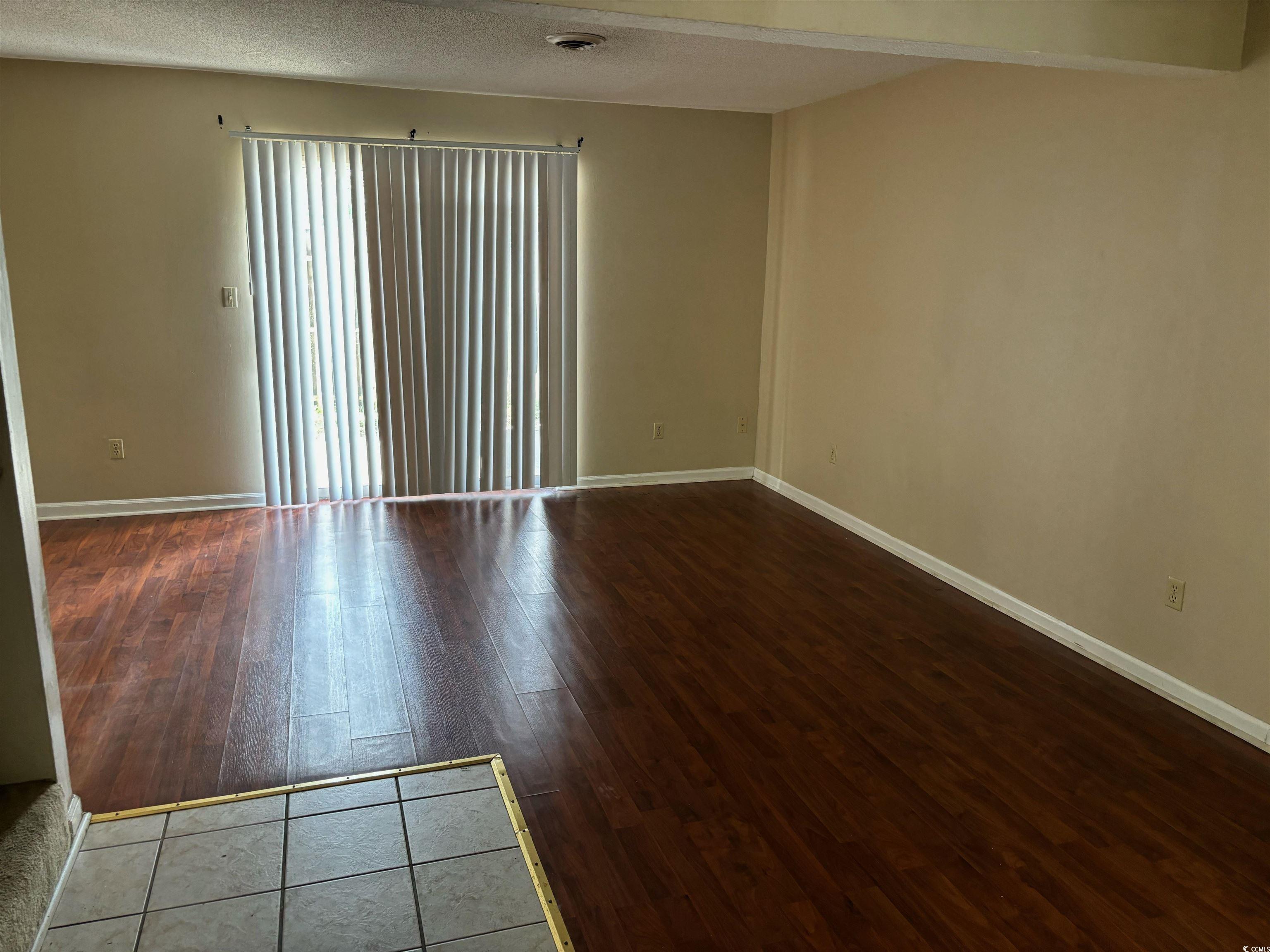 1025 Carolina Road, Unit G3 Conway, SC 29526 - Photo 10 of 11 Unfurnished room featuring a textured ceiling and hardwood / wood-style floors