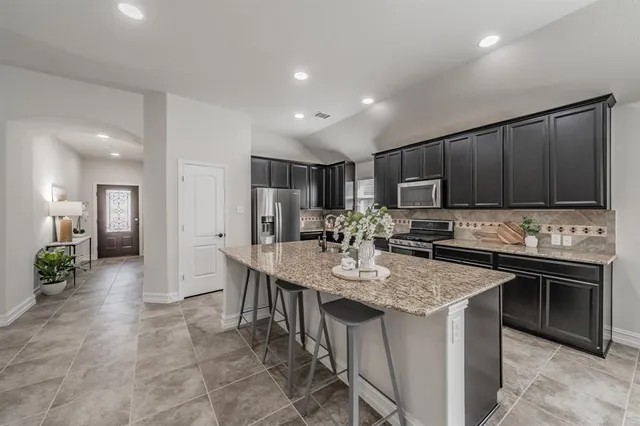a kitchen with sink cabinets and stainless steel appliances
