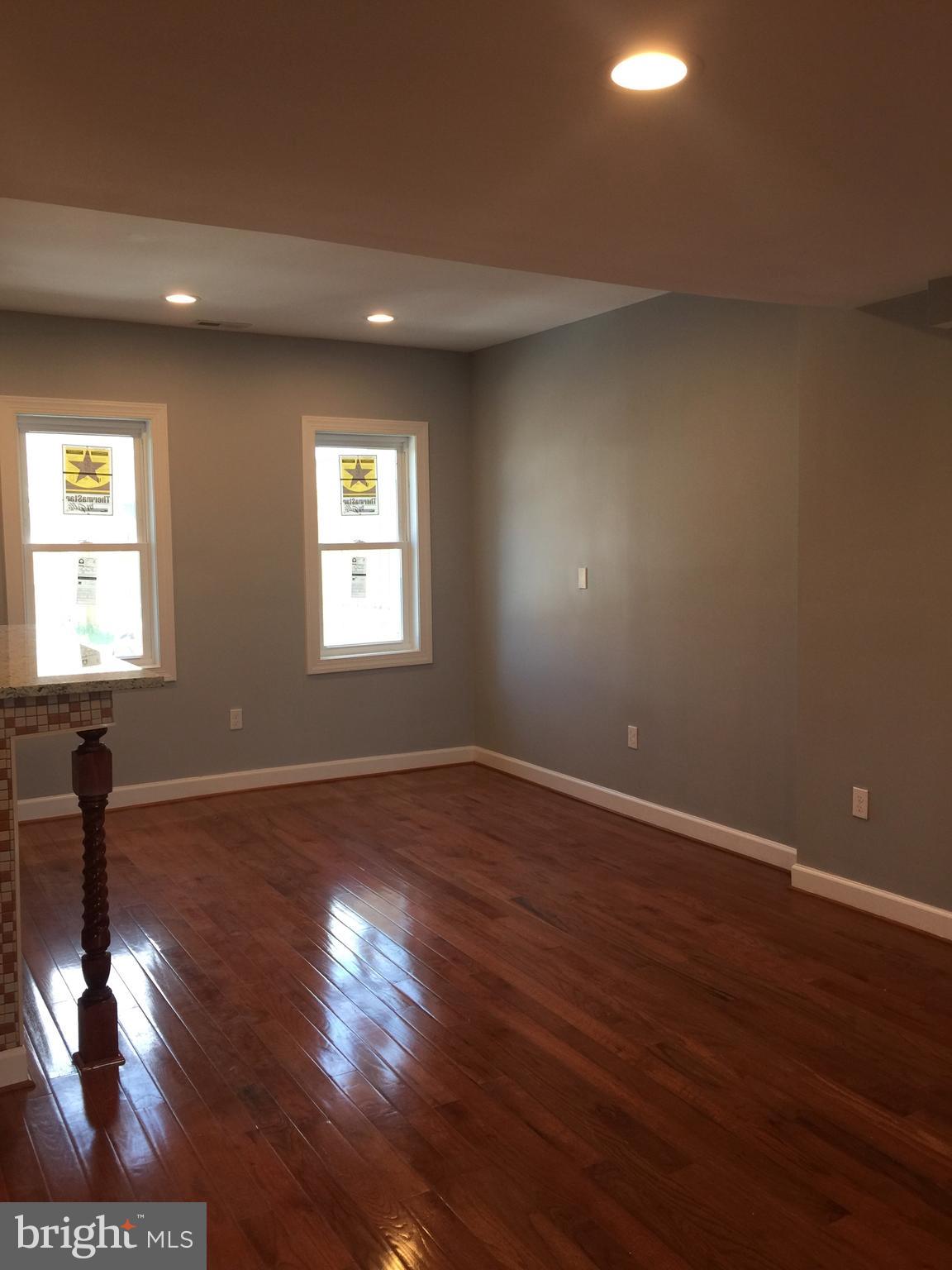 1049 Desoto Road Baltimore, MD 21223 - Photo 8 of 47 a view of empty room with wooden floor and fan