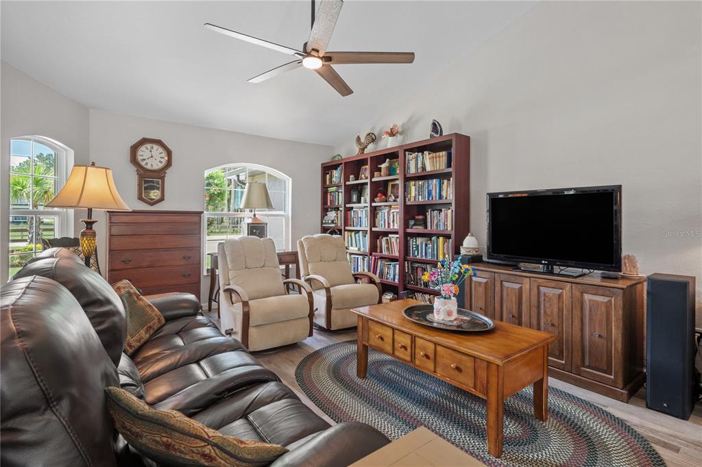 12929 Southwest 89th Street Dunnellon, FL 34432 - Photo 4 of 76 a living room with furniture and a flat screen tv