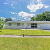 a view of a house with a backyard and a patio