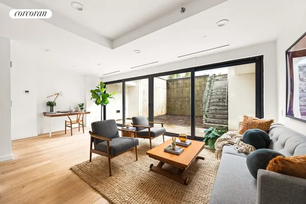 a living room with furniture and a floor to ceiling window