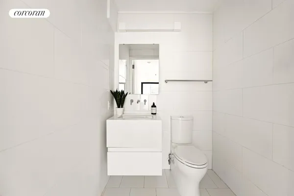 a spacious bathroom with a tub shower and a sink
