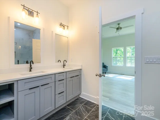 a bathroom with a double vanity sink and mirror