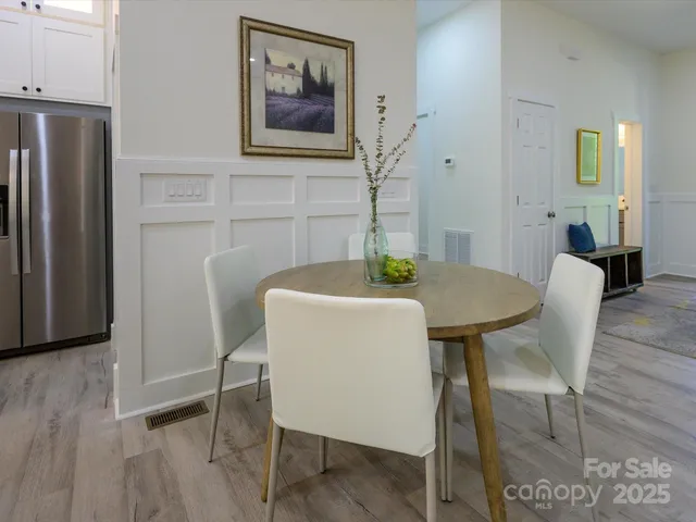 a dining room with furniture and wooden floor